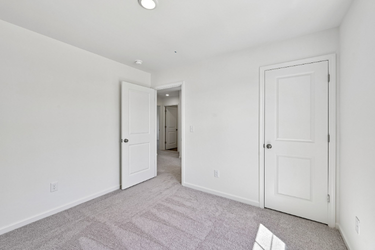 A hallway with white doors.