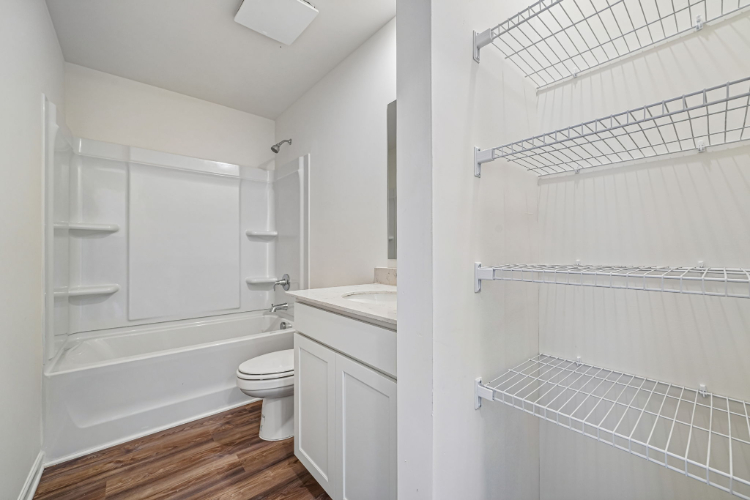 A bathroom with a tub toilet and sink.