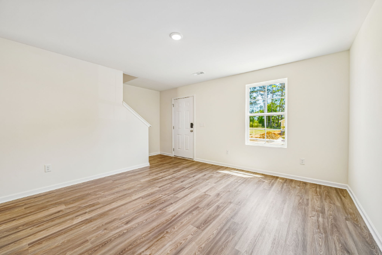 A room with a wood floor and a window.