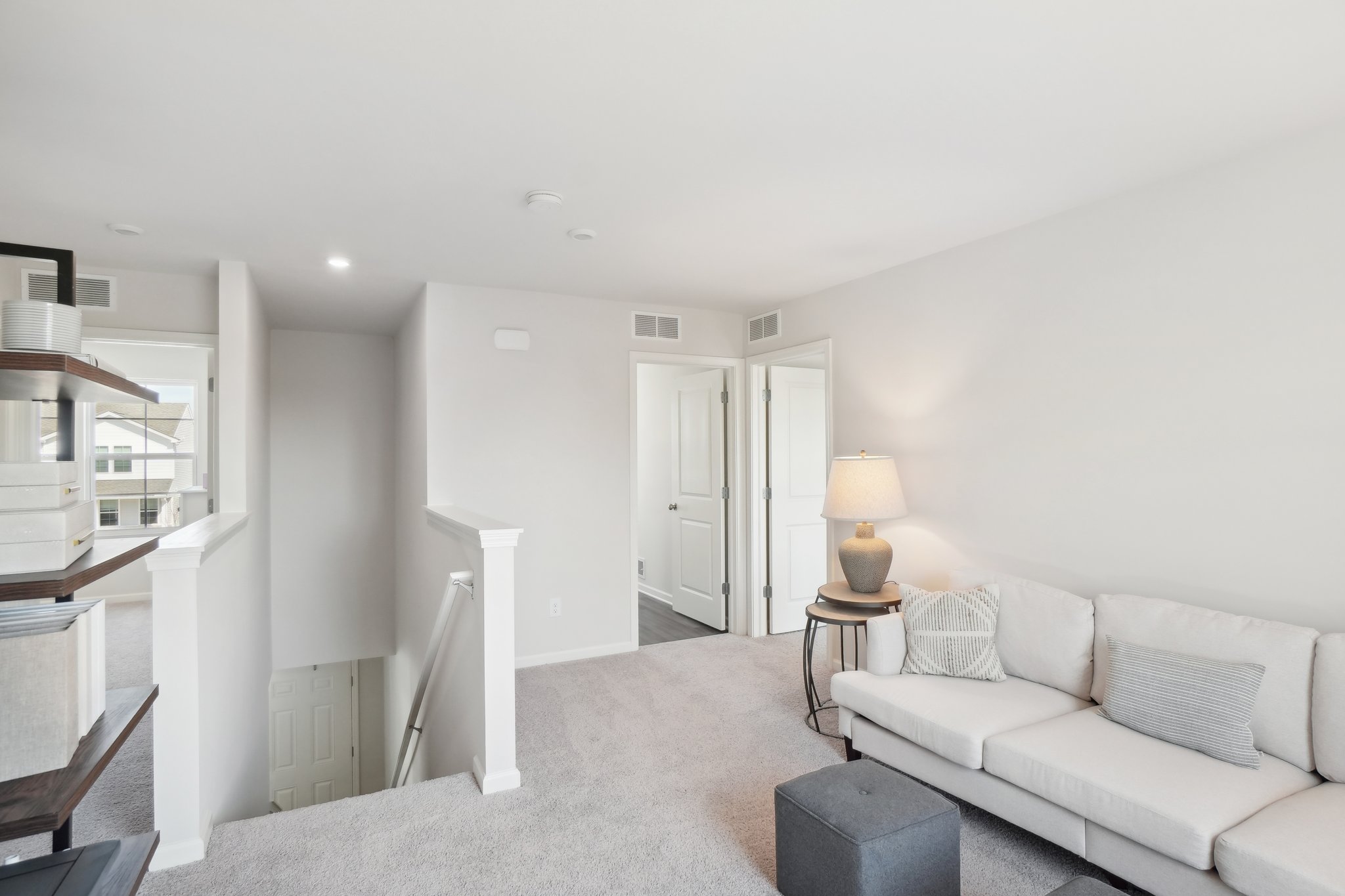 A living room with white furniture.