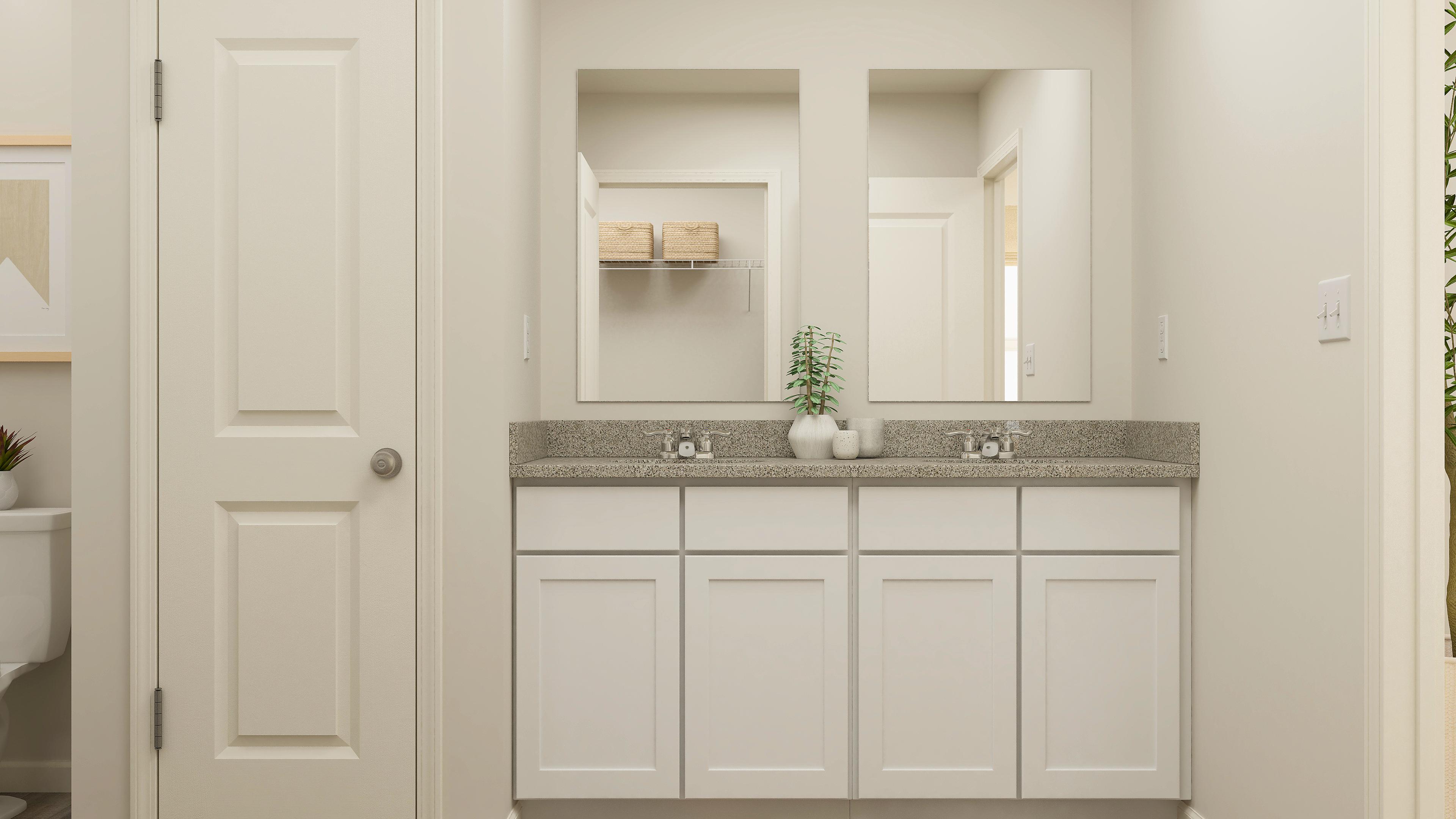 A white kitchen with a marble countertop.
