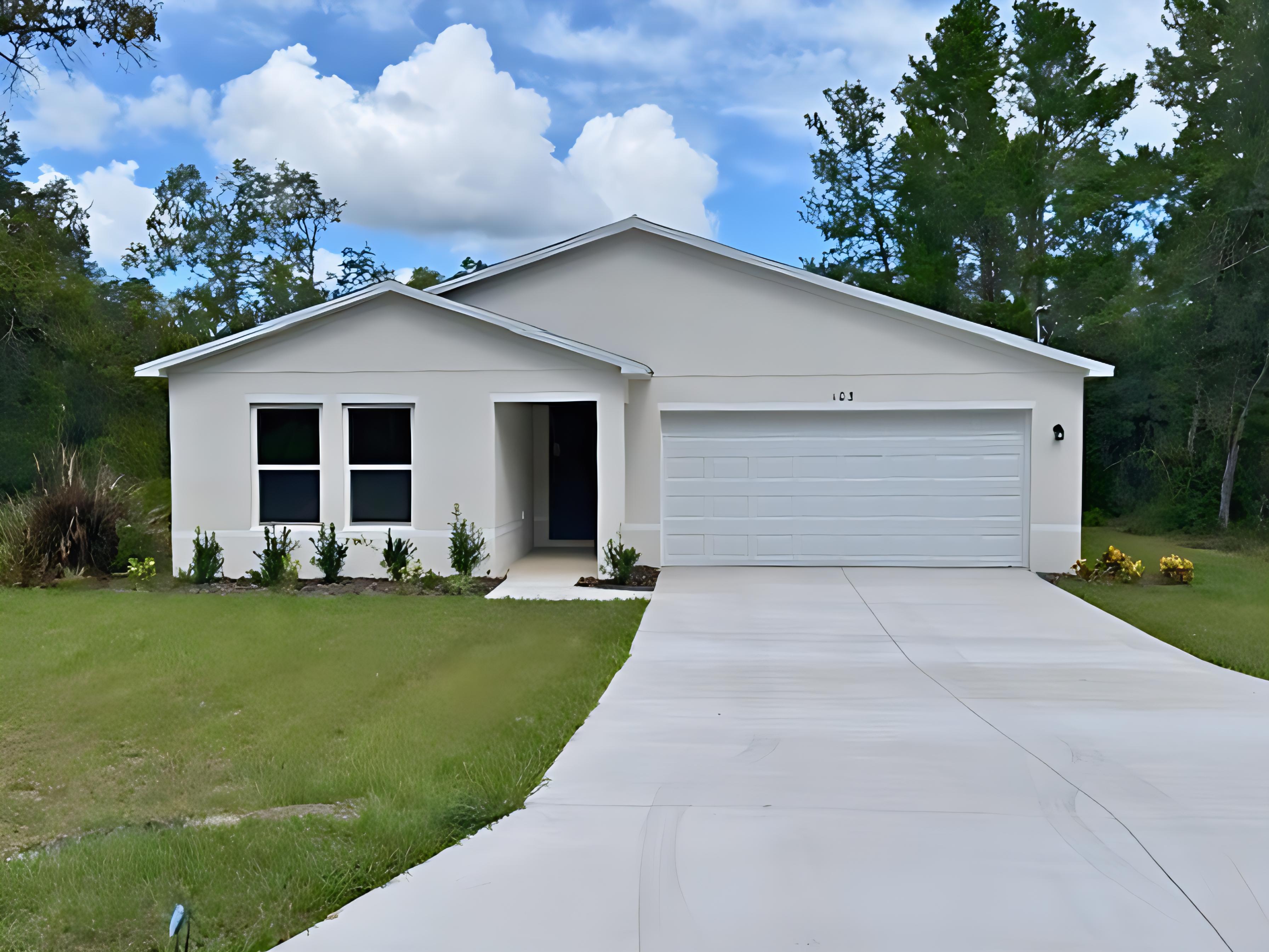 A white house with a driveway.