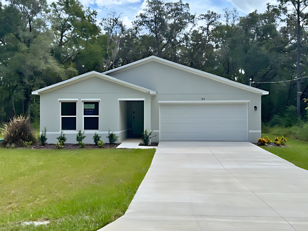 A white house with a driveway.