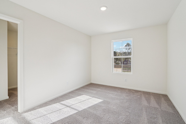 A room with a window and a tile floor.
