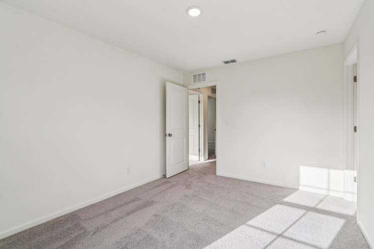 A hallway with white walls.