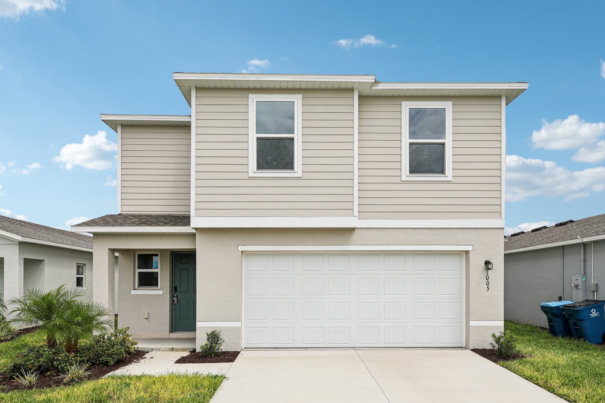 A white house with a garage.