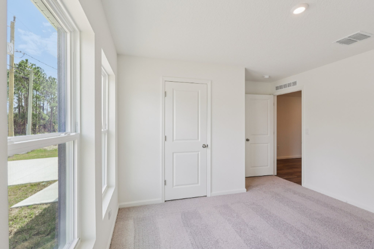 A hallway with white doors.