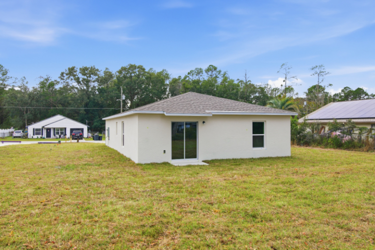A white house in a grassy field.