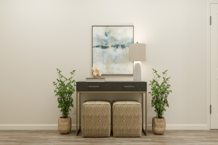 A desk with a plant and a chair in front of it.