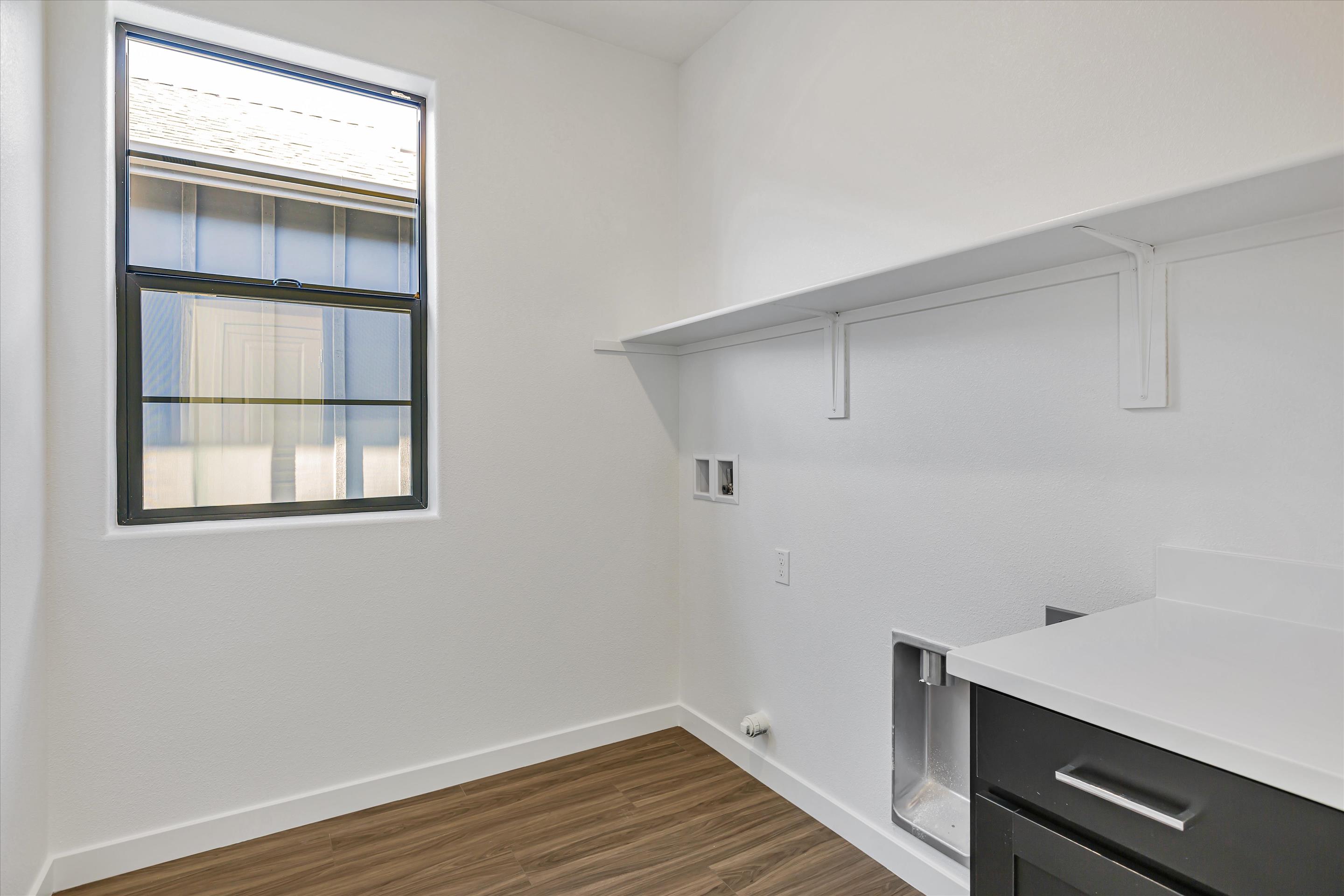 A room with a window and a sink.