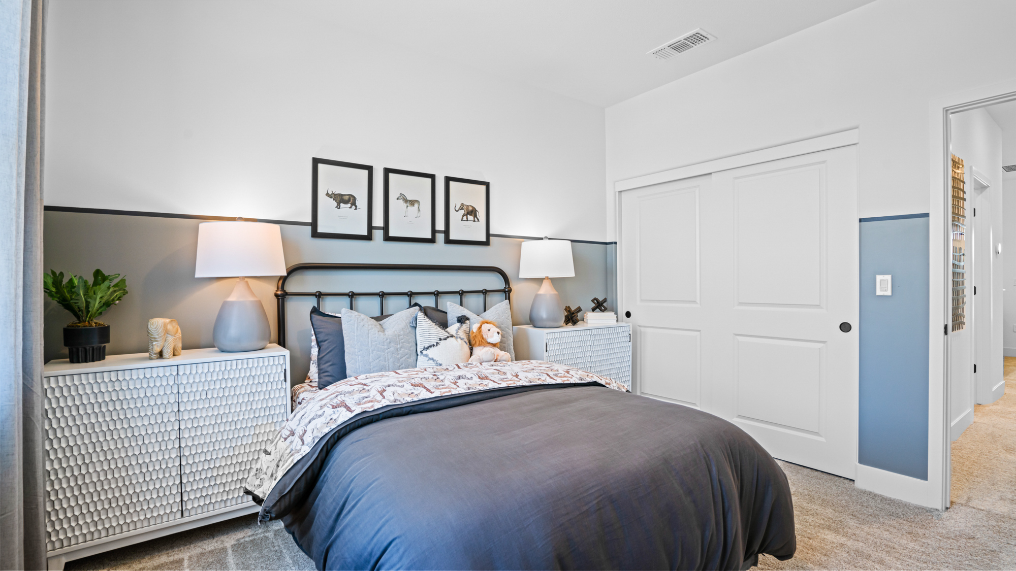 A bedroom with a bed and lamps.